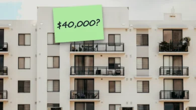 A white condo building with rows of balconies under a gray sky, with a sticky note reading “$40,000?”.